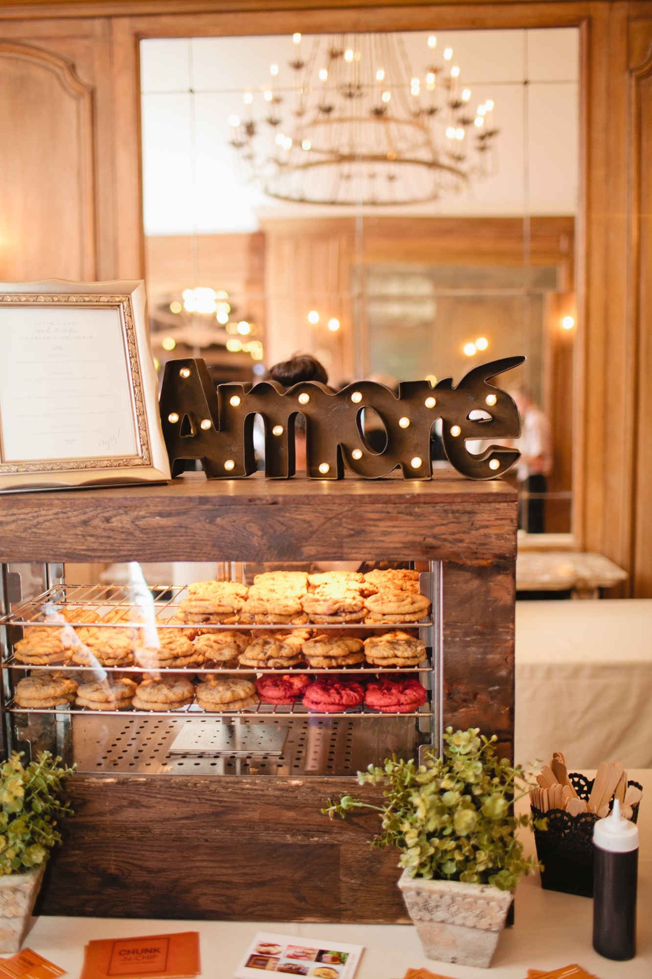 Chunk-N-Chip warm cookie display case with candles at an elegant ballroom event