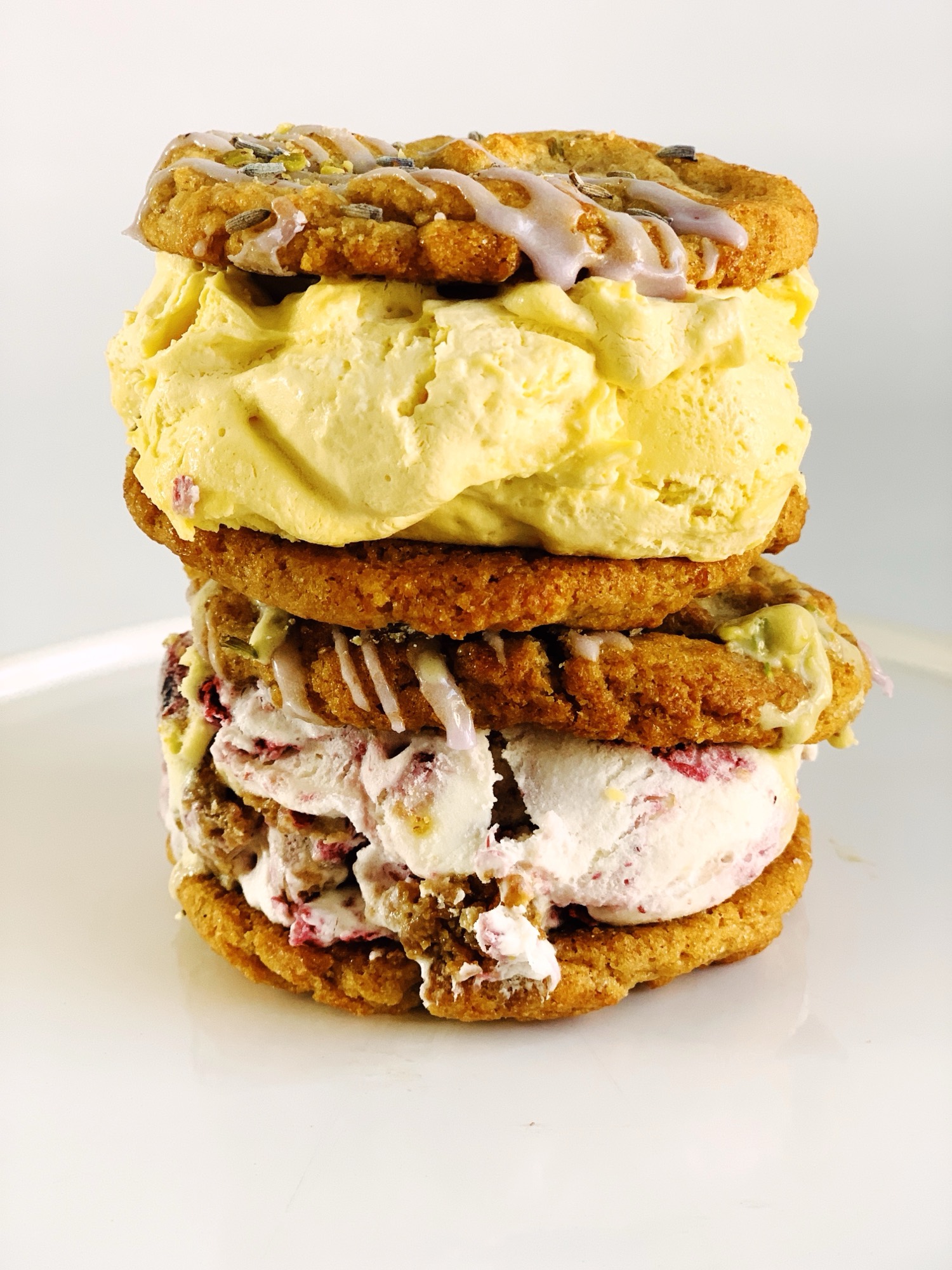 Two Chunk-N-Chip cookie ice cream sandwiches stacked on a white plate