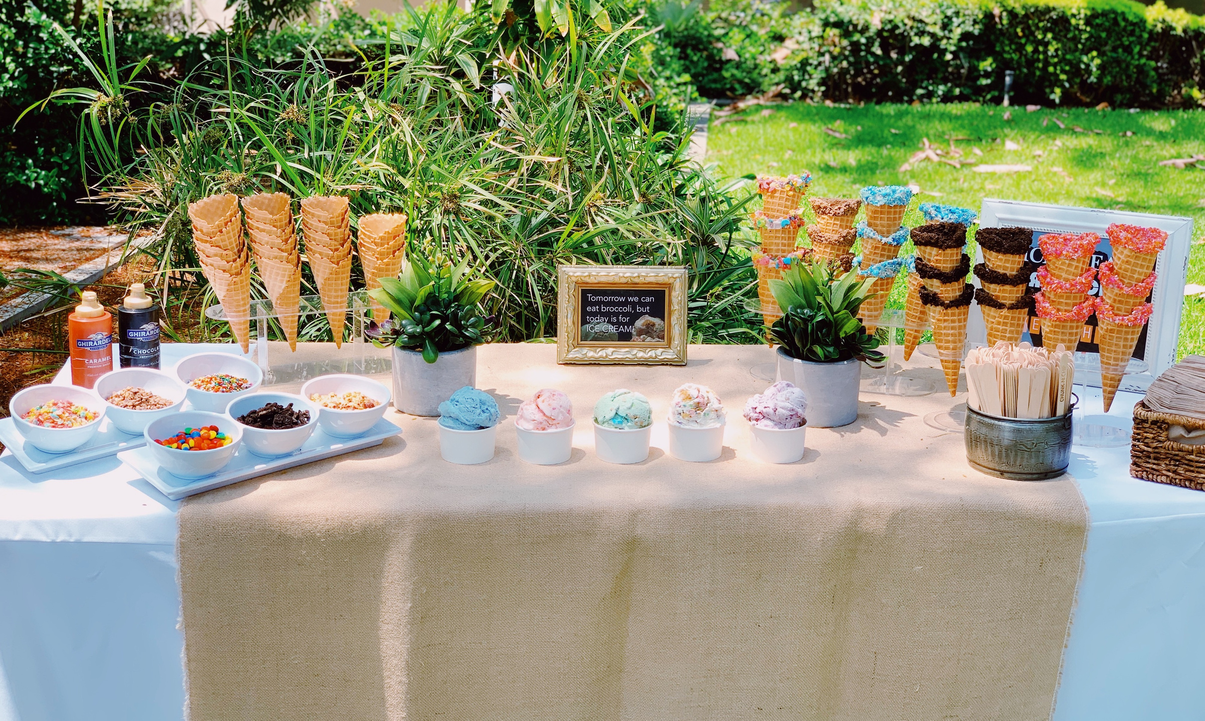 A Chunk-N-Chip sundae bar displaying ice cream cups, cones and assorted toppings