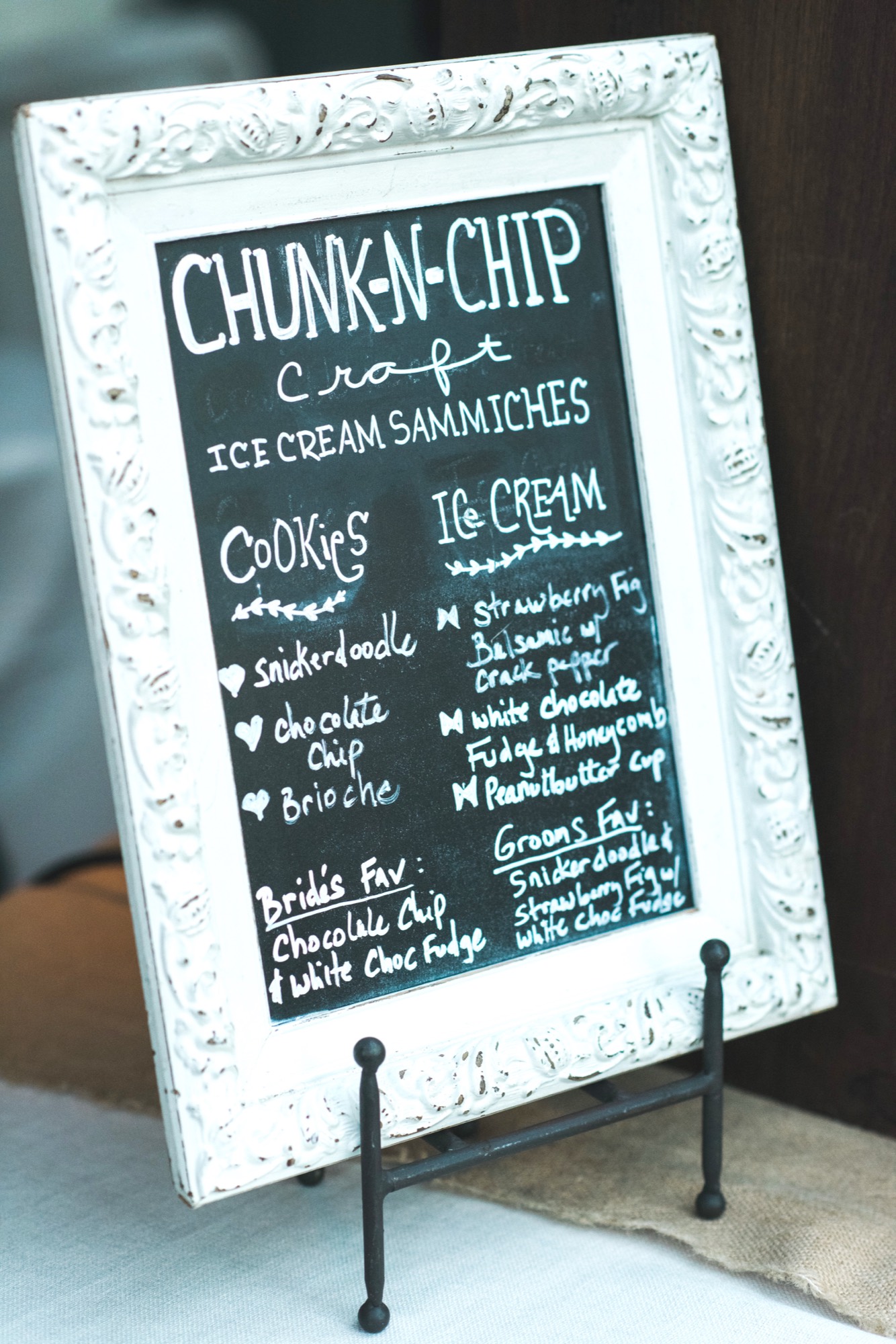 Framed chalkboard menu of Chunk-N-Chip craft ice cream sammich flavors at a wedding