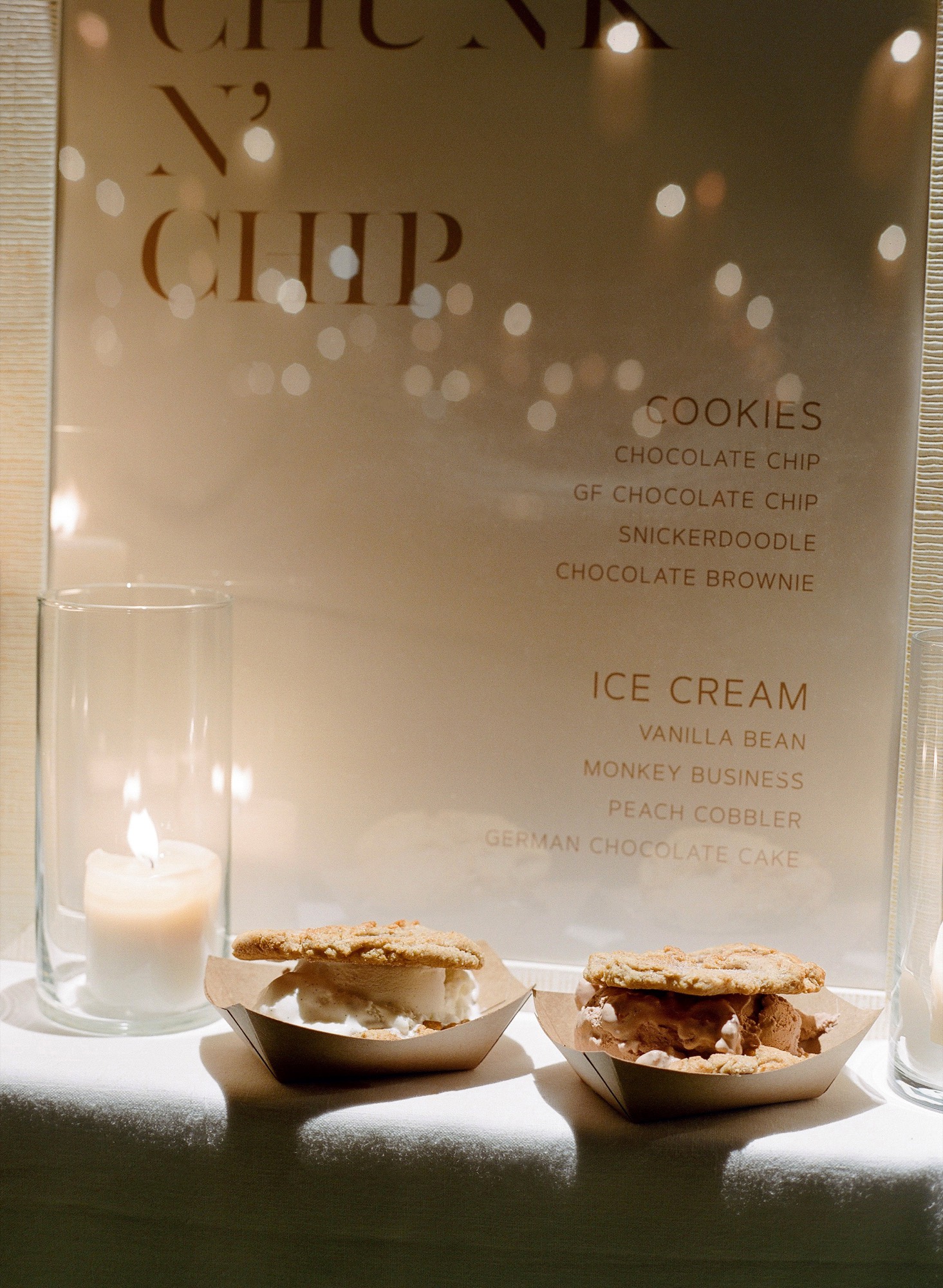 Candlelit Chunk-N-Chip dessert menu with two ice cream sammiches at a wedding reception